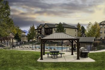 A covered picnic area with a pool 